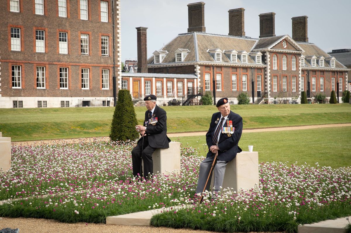<i>Normandy veterans pause in the "D-Day Revisited Garden" designed by John Everiss Design, at the RHS Chelsea Flower Show during press day in London, May 20, 2019. Photograph by Suzanne Plunkett/RHS</i>