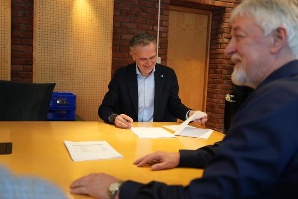 Henning Vellene (t.v.) i Norconsult signerer avtalen med Jan Kinserdal i GK. Foto: Norconsult