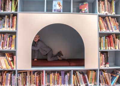 Troy Fjeld-Lundby (6) er storfornøyd med det nye kjempebokhyllemøbelet på barneavdelingen på Holmlia bibliotek.