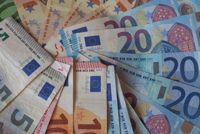 Euro (EUR) banknotes and coins, currency of European Union (EU) useful as a background