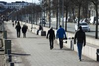 Finland går till val i uppehållsväder, låter prognoserna tro. Här är människor ute på promenad längs Norra kajen i Kronohagen.