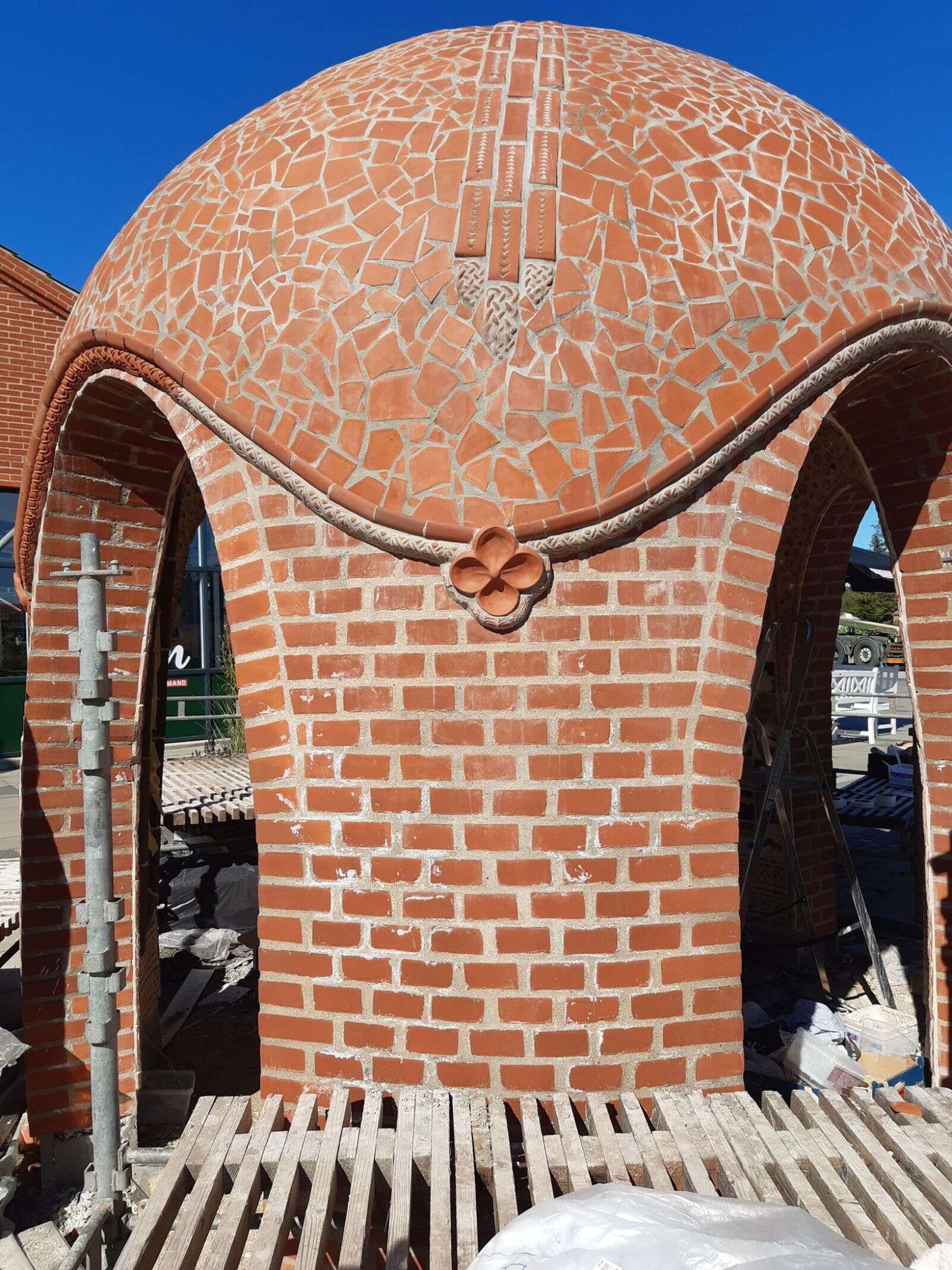 Den runde mosaik-skulptur har fået form og detaljer. Kunstnerparret fra Lund regner snart med at blive helt færdig med værket. Privatfoto