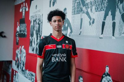 Julius Emefile har taget opstilling ved Sergei Sviatchenkos kunstneriske vægkollage ved indgangen til Dream 99. Den 18-årige kantspiller trives godt i de nye rammer og er blevet en profil i U19 Ligaen.