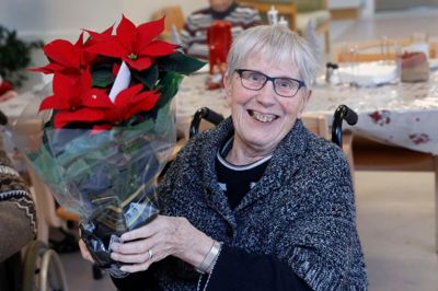 Grete Sørensen, der er beboer på Kildehøj, var glad for den flotte blomst. Den skulle i en urtepotte og pynte på hendes værelse. Grete Sørensen skal fejre jul på plejehjemmet, hvor hendes datter også kommer.