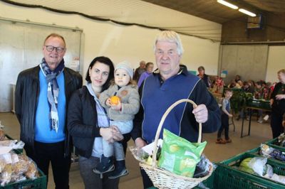 Formanden for Stop Madspild Silkeborg, Sven Petersen (tv), var mødt frem til den store aften i Kjellerup og medlem af bestyrelsen, Jens Larsen, overrakte en kurv og et gavekort til Liudmyla Lupy og sønnen Damian. Foto: Morten Hallstrøm