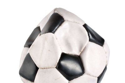 Deflated soccer ball isolated on white background.