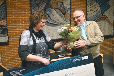 Bjarne Dueholm får her prisen på 5.000 kr. overrrækt af næstformand i Handicaprådet, Sonja Bach Møller.