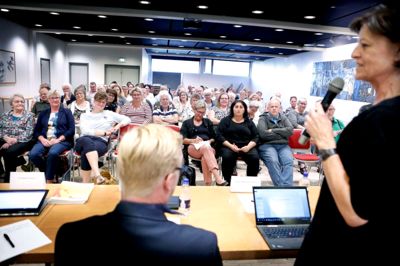 Folkemødet i bibliotekets samlingssal trak omkring 80 mennesker af huse. Hovedparten var personale fra sundheds- og omsorgsområdet. Med mikrofonen er det folketingsmedlem Kirsten Normann Andersen (SF).? Foto: Henrik Ole Jensen
