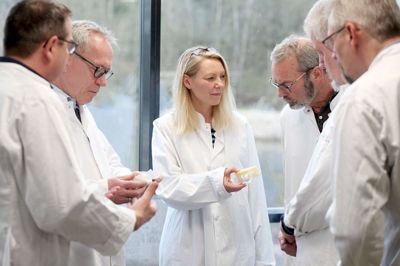 Dina Raabjerg studerer her et stykke ost fremstillet ved hjælp af kartoffelstivelse. Fra venstre ses desuden KMC's økonomidirektør Henrik Borum, Poul Elmegaard (RV), KMC-jurist Axel Bonde, Thue Grum-Schwensen (SF) og Erik Poulsen (V). Foto: Mikael Lund