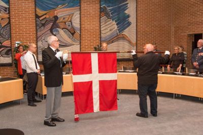 Fanen, der er doneret af Danmarks-Samfundet, står opstillet i byrådssalen. Foto: Flemming Staal