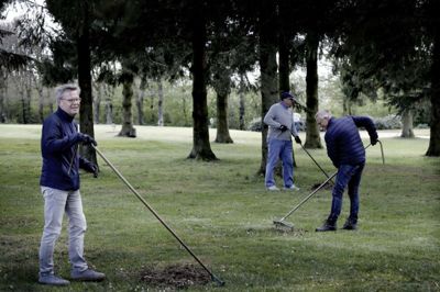 Dion Eriksen (t.v.), Søren Kristiansen og i baggrunden Bo Jensen var ude med riven for at hjælpe til med at gøre golfbanen klar til sæsonen. FOTO: HENRIK OLE JENSEN