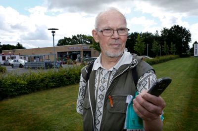 Arne Lock ved et af de 20 steder, i Sunds hvor han med sin smartphone kan få en historie fortalt om stedet. Her foran Rema 1000 lå engang byens kro. Blandt andre punkter er fattiggården på Thorupvej, historien om hvorfor Sunds IF's træningsanlæg ligger uden for byen og hvordan Unimerco, der i dag hedder Kyocera, har udviklet sig.? foto: henrik ole Jensen