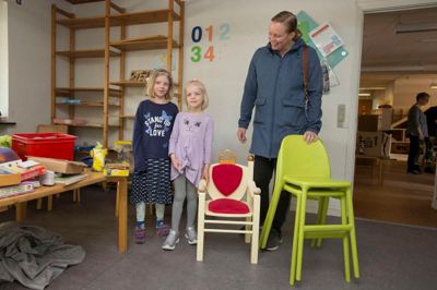 De tre tidligere børnehaver i Bording har langt fra taget alt med sig over i den nybyggede og samlende børnehave. Derfor var der lørdag loppemarked, hvor man kunne købe alt fra puslespil til reolsystemer. Seksårige Linnea Poulsen (i midten) kastede sin kærlighed på »Kongestolen«, som mor Linda gladelig betalte - på betingelse af at storesøster Simone også må sidde i den. ?Foto: Tom Laursen
