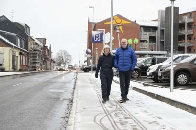 Aulum har skiftet karakter. De fleste butikker er væk, og »højhuset« - i baggrunden har taget udsynet for møllen, som ellers var et vartegn, når man kom ind i byen fra nord. Men Tove Baunbæk Nørkjær og Erik Nørkjær glæder sig stadig over deres by. Foto: Tom Laursen
