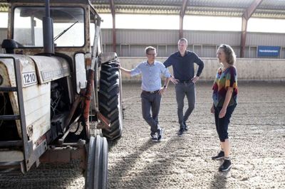 Den gamle traktor fra 1970’erne skal skiftes ud med en ny John Deere, så underlaget i ridehallen kan blive vedligeholdt og plejet på bedste vis. Sidste efterår fik klubben ny fiberbund, som blandt andet sikrer bedre affjedring for hestene, og så støver banen ikke. Bitten Römhild fortalte om klubben, da der i går var besøg af folkene fra Spar Nord Herning: afdelingsdirektør Morten Grønne-Reinholdt (t.v.) og kundemedarbejder René Villadsen. Foto: Tom Laursen