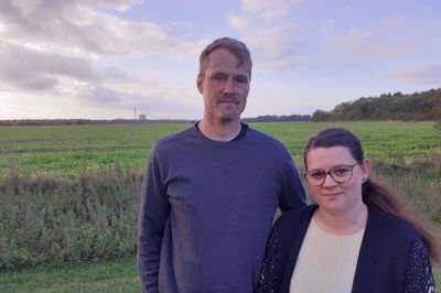 Lisa Skjærbæk og Morten Damholt får den planlagte Energipark Motorkryds Herning lige op til deres baghave. Vindmøllerne i projektet kan blive næsten dobbelt så høje som skorstenen på Herningværket, der ses i baggrunden. Den nærmeste vindmølle skal efter forslaget rejses 600 meter fra parrets ejendom. Foto: Jesper Wind