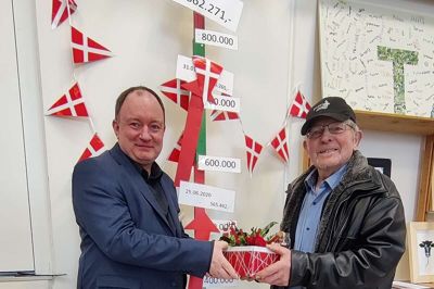 Lederen af Aulum Kristne Friskole, Henrik Olesen (t.v.), takker her Filip Fuglsang for at have doneret 1 million kroner til skolen ved at sælge gammelt jern gennem 13 år. I baggrunden ses »indsamlingsbarometeret«.