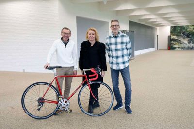 Henning Jørgensen (t.v.) har doneret den cykel, han kørte sine sidste konkurrencer på, til Maria og Kim Wiche, der har ønsket at bevare en lille del af den tidligere cykelbutik i lokalerne, når de rykker ind med Frisør Morgenhår.