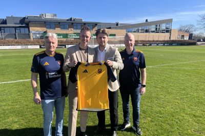 Søren Hansen (tv), Nikolaj Drews (nummer to fra venstre), Mads Fyrstenborg Sørensen og Jørgen Trankjær (th), kendt som Jønne har givet hinanden hånd på, at for hver hus mæglerkæde John Frandsen fælger i postnummer 7480 Vildbjerg, så ryger der 1000 kroner i sponsorkassen hos Vildbjerg SF Fodbold.
