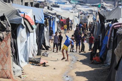 Fredag ses børn lege i en teltlejr for fordrevne palæstinensere i Gaza City.