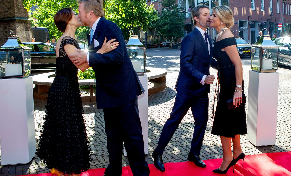 De to kongelige par hilser på hinanden ved ankomsten til middagen i Haag mandag aften.