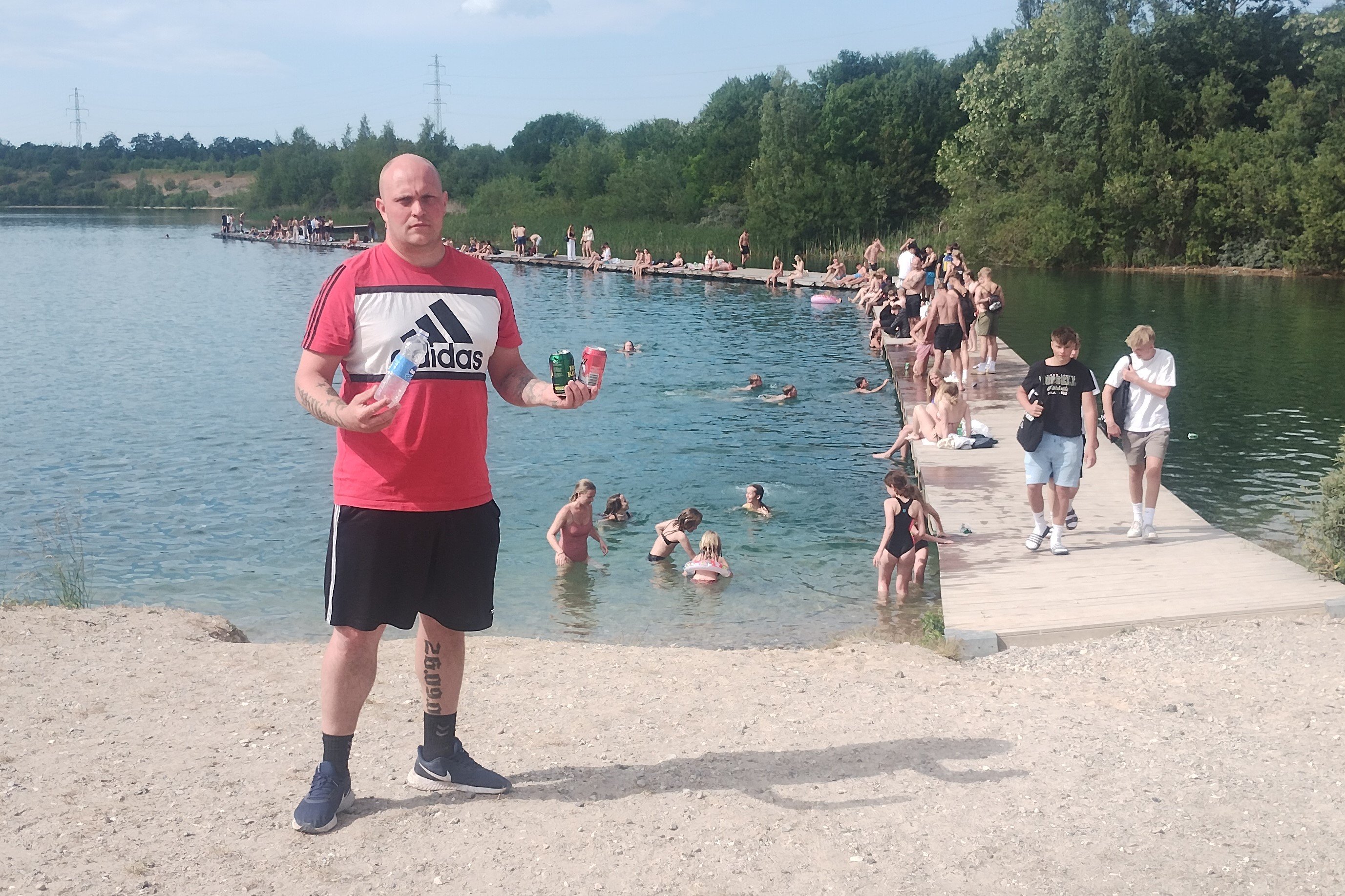 Bjarke Dolward Sørensen med nogle af de flasker og dåser, som Himmelsøens brugere har smidt fra sig. Privatfoto