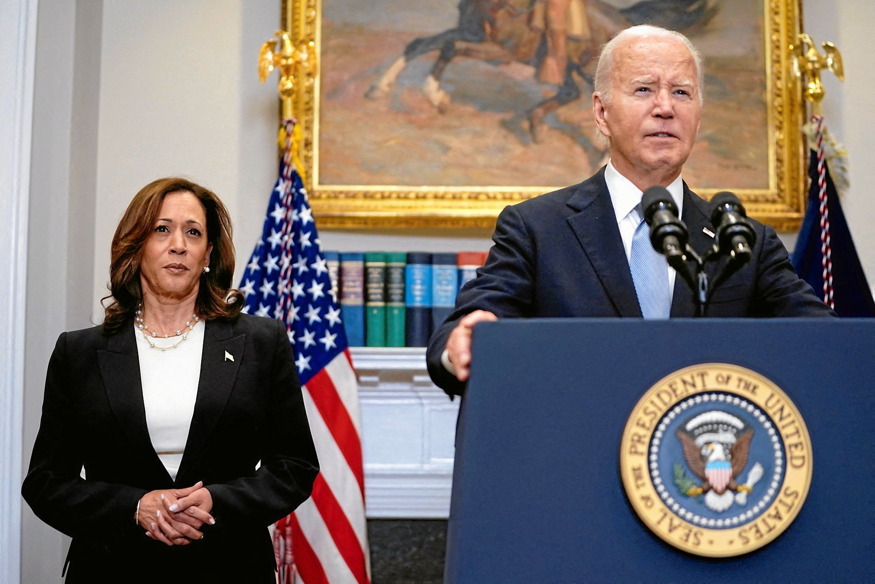 FILE PHOTO: U.S. President Joe Biden speaks next to Vice President Kamala Harris as he delivers a statement a day after Republican challenger Donald Trump was shot at a campaign rally, during brief remarks at the White House in Washington, U.S., July 14, 2024. REUTERS/Nathan Howard/File Photo