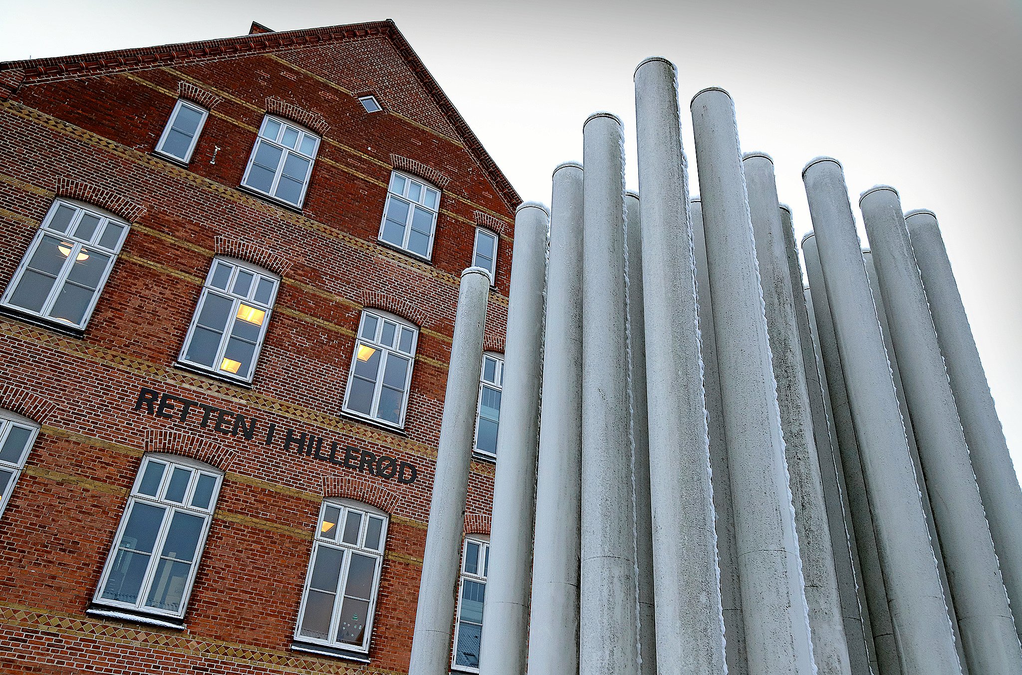 En læge er tiltalt for adskillige overgreb mod sine to små døtre.