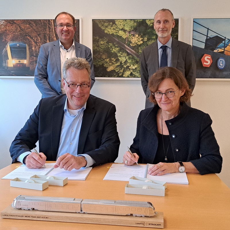 Dr. Ansgar Brockmeyer, Executive vicedirektør for Marketing og Salg hos Stadler (til venstre), skriver kontrakten under sammen med Lokaltogs bestyrelsesformand, Dorthe Nøhr Pedersen. Bag dem står Michael Schwarz, direktør for Marketing og Salg hos Stadler i de nordiske lande, sammen med Lars Wrist-Elkjær (til højre), administrerende direktør i Lokaltog. - Lokaltog Dr. Ansgar Brockmeyer, Executive vicedirektør for Marketing og Salg hos Stadler (til venstre), skriver kontrakten under sammen med Lokaltogs bestyrelsesformand, Dorthe Nøhr Pedersen. Bag dem står Michael Schwarz, direktør for Marketing og Salg hos Stadler i de nordiske lande, sammen med Lars Wrist-Elkjær (til højre), administrerende direktør i Lokaltog.