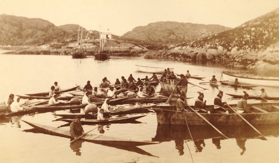 Under Grønlandsrejsen i 1884 tog Haldor Topsøe dette billede af grønlændere i kajakker og robåde og med danske sejlskibe i baggrunden.