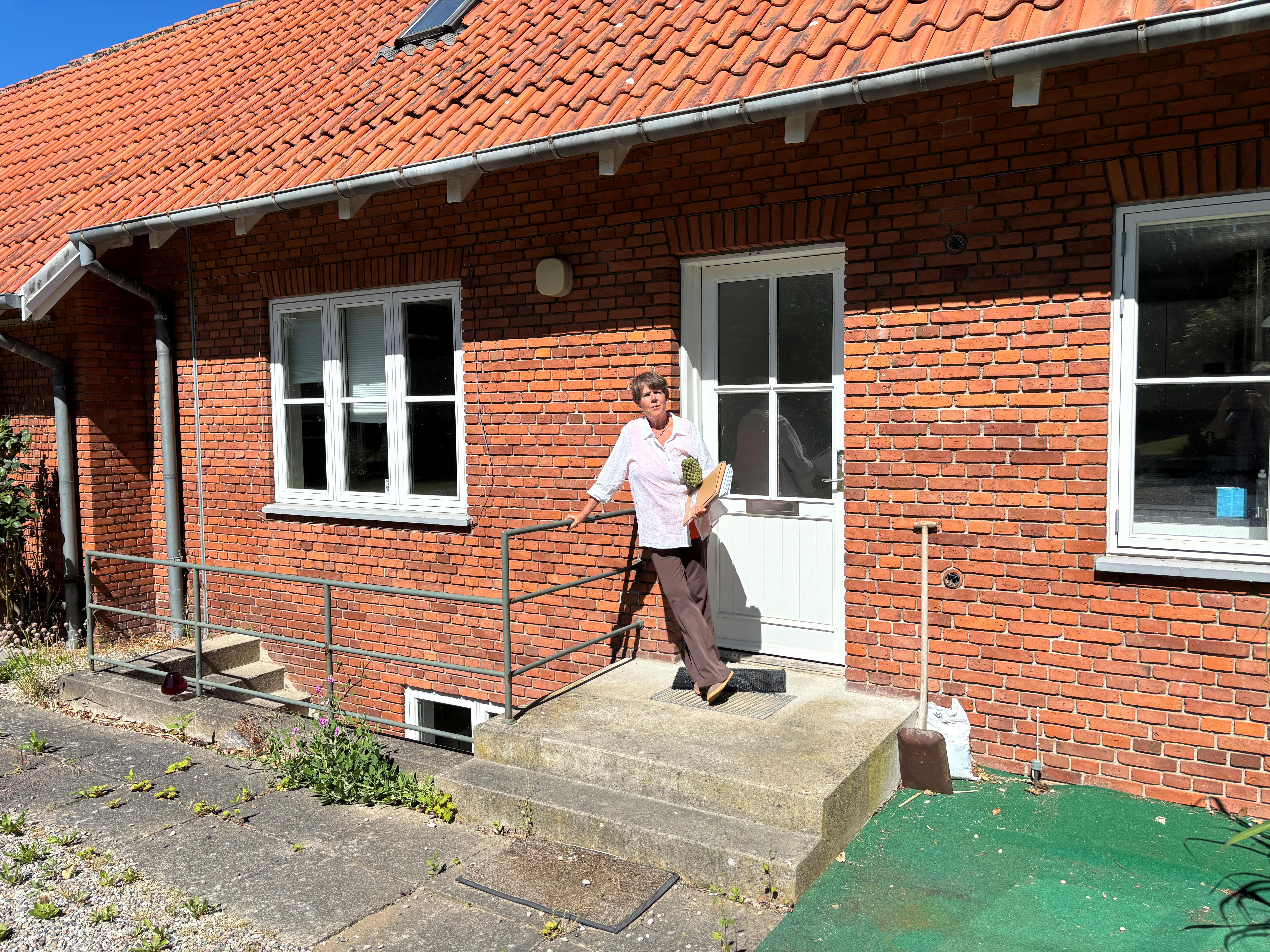 Menighedsrådsformand Winnie Frisenette-Fich uden for den nu tidligere præstebolig i Tømmerup. Bygningen er alvorligt ramt af skimmelsvamp. Dermed har Tømmerup Sogn hverken præstebolig eller konfirmandstue til rådighed.