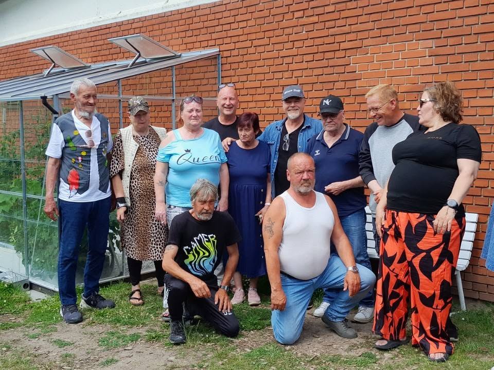 Robert Hansen, siddende i hvid undertrøje, blandt venner. Bisættelsen finder sted onsdag den 12. august.